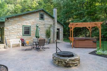 Back patio and hot tub at couple's cottage