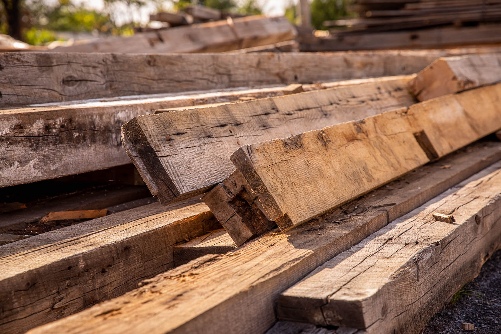 Stack of old reclaimed wood barn beams after a barn demolition.
