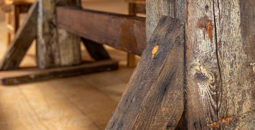 Detail shot of table built from repurposed barn wood