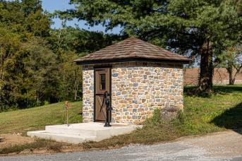 Pump house with stone and cedar roof