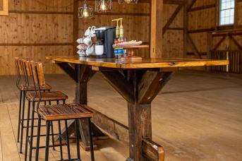 Table, stools, and light fixture made from reclaimed barn timbers.