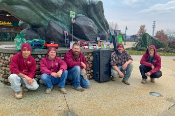 The crew who won the safety challenge displays their winnings outside Cabela's.