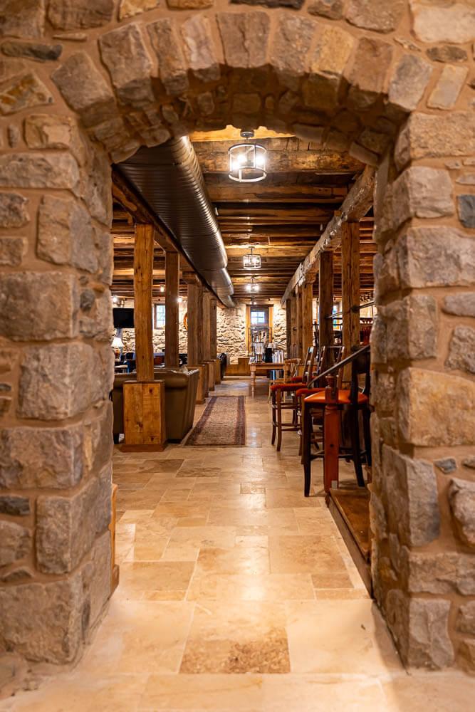 an arched walkway was added through the 35-foot exterior wall of the original to connect the tasting room with a modern kitchen.