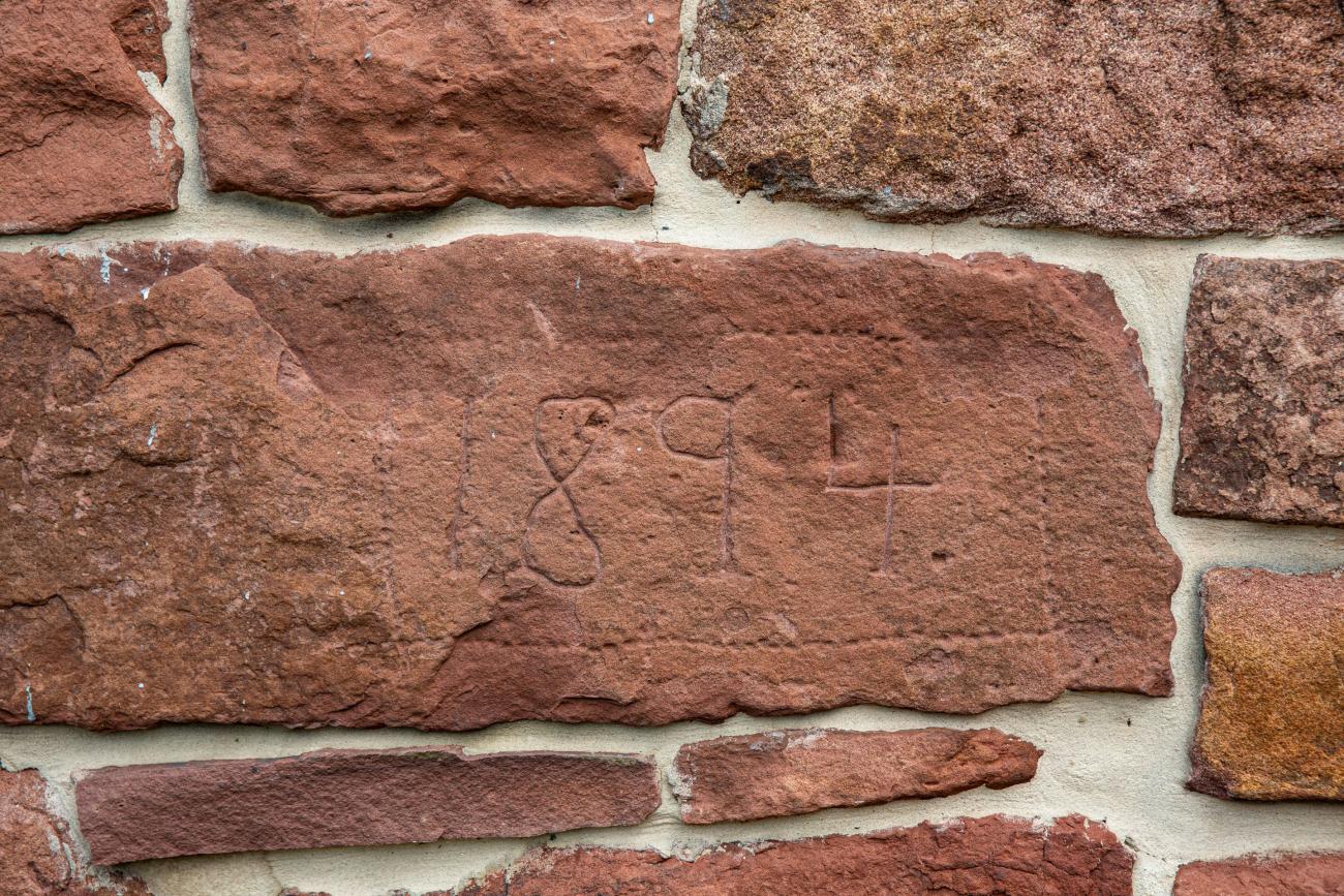 date stone restored in barn