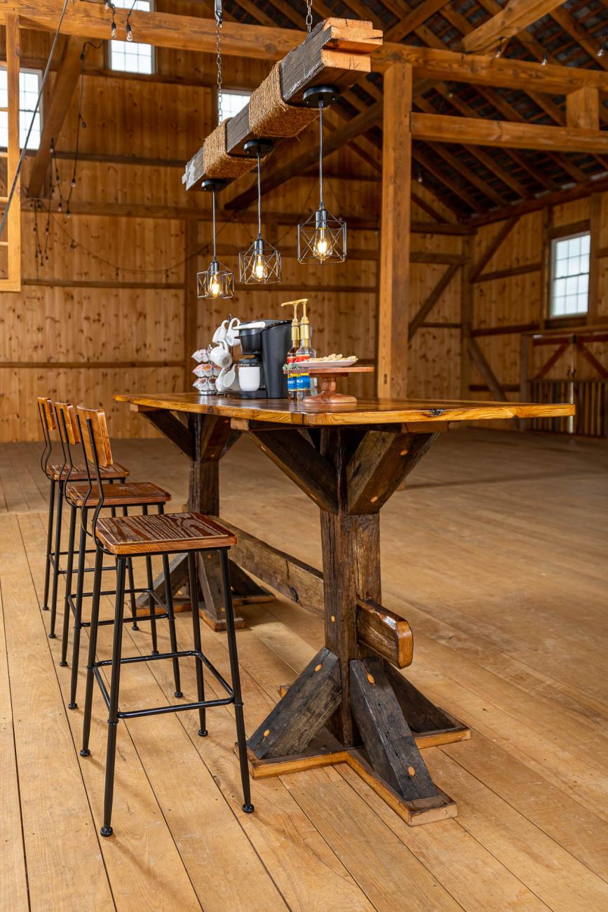 Table, stools, and light fixtures made from reclaimed barn timbers